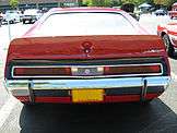 Shows the standard duck-tail rear spoiler of the AMX model - finished in red