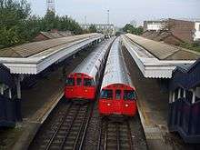 A Bakerloo Line train departs Willesden Junction railway station, bound for Elephant and Castle. The trains are so low the platform is actually a step UP.