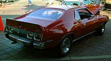 Shows the rear right of a 1973 AMC Javelin Pierre Cardin edition finished in red