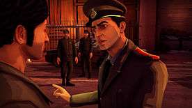 The player character is facing a police officer, who is berating him. Two officers stand in the background, near a police cruiser.