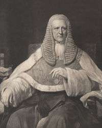 A black-and-white photograph of John Coleridge. He is wearing Justice's robes, a gold chain around his sholders, and a large ruffled wig.