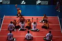 People playing sitting volleyball