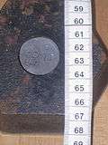 A hexagonal 2kg weight – bottom view showing lead plug and assayer's stamp