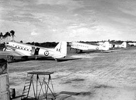 Black and white photograph of five silver aircraft parked in a line