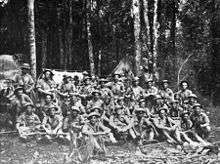 A group of weary soldiers in a jungle scene