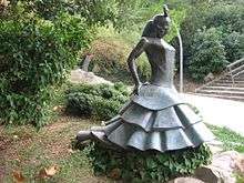 grey statue of a woman in a park