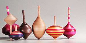 Seven wooden tops in a variety of shapes and colors