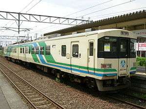 Cream and green-colored Abukuma Express train at Tsukinoki Station