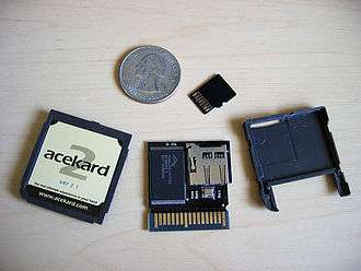 Larger flashcart, shown with small card and U.S. quarter for size