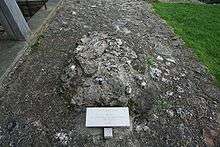 Pile of stones marked with a tag reading "St. Augustine, Site of Grave, First Archbishop of Canterbury