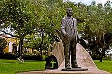Statue in park of smiling African man in a suit