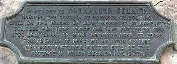 Bronze plaque in memory of Selkirk affixed to a building