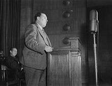 Henderson standing at a podium