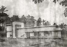 A black-and-white photograph of a studio building