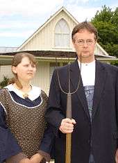visitor's wearing period-style clothing, and with props such as a pitchfork and glasses