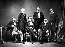 Studio black and white portrait of American High Commissioners. Sec. Hamilton Fish seated in center.