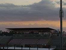 Covered grandstand against a cloudy sky