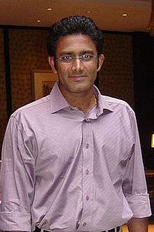 Photo of young man wearing lavendar shirt and unframed eyeglasses