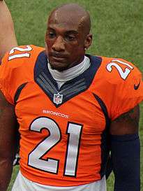 An American football player looks straight ahead just to the right of the camera. He is not wearing a helmet.