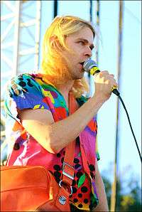 Ariel Pink singing wearing a colorful shirt