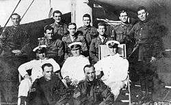 A group portrait of ten soldiers and three sailors on board a ship