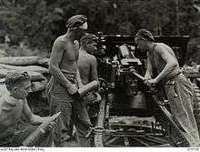 Gunners load and fire an artillery piece