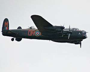 Colour photograph of a Lancaster Bomber in flight