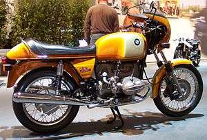 Gold BMW R90S motorcycle in gleaming showroom condition