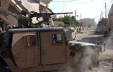 Picture of a soldier in a Humvee
