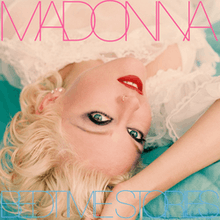 Upside down image of Madonna laid down in a bed, wearing heavy makeup with her hand to her head, with "Madonna" written in pink capital lettters, while "Bedtime Stories" is written in sky-blue capital letters.