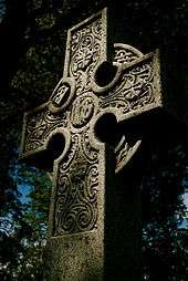 A stone Celtic cross in Beechwood Cemetery