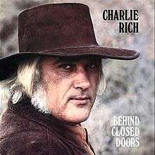 Cover of the Behind Closed Doors album with the singer Charlie Rich in a cowboy hat.