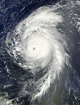 Satellite image of a mature hurricane over the open Atlantic displaying several characteristics of an intense hurricane, including an eye at the center and large spiraling rainbands