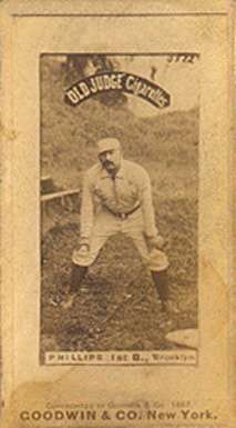 A man in a baseball uniform is crouched slightly with his hands on his knees.