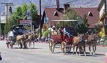 photo of two mule-drawn wagons in the Bishop Mule Days parade