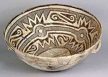 A color picture of a black and white bowl with geometric designs