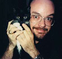Artist Brad Foster, with his cat Sable