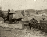 Monochrome photograph of farm buildings