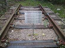 Short length of railway track and a metal sign