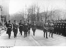 Werner von Blomberg inspects a parade in his honor on his birthday. Soldiers with Guns stand to attention.