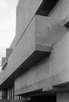 Imposing grey concrete blocks of 20th-century modernist architecture.