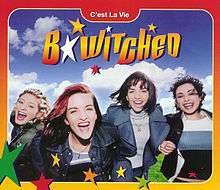Image shows B*Witched dancing around a lush green field on a beautiful sunny day. The words "B*Witched" and "C'est La Vie" are written on the picture. There is also an orange and yellow gradient border around the photo with green, red, yellow and orange stars at the bottom of the image.