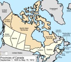 Map of the country of Canada on September 1, 1905, depicting the larger postage stamp sized province of Manitoba along with the provinces of Ontario, Prince Edward Island, Quebec, New Brunswick, British Columbia and Nova Scotia, in the colour white. The disputed area between Manitoba and Ontario is resolved, Ontario expands west to the Lake of the Woods and north to the Albany River. Alberta and Saskatchewan provinces are added from land formerly the NWT. Provinces are coloured white. The North-West Territories is separate from the District of Keewatin north of Manitoba. Territories are depicted in the colour pink; the northern arctic islands are a part of the NWT. The District of Keewatin now has a geographically shaped border to encompass the eastern borders of the newly formed provisional districts of the NWT. Yukon Territory is now formed from the NWT, and is expanded. The area called Newfoundland, Labrador, and Alaska are depicted in bluish grey colour, and are not a part of Canada.
