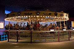 Brightly lit carousel with animals