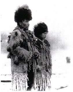 Black and white photograph of Skwxwu7mesh Chief George from the village of Senakw with his daughter in traditional regalia.