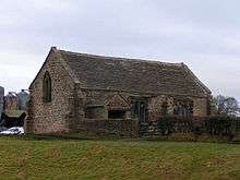 A small rectangular building with a porch but no decoration, tower or bellcote.