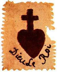 Picture shows a patch with a dark heart topped by a Christian cross. The patch is labeled Dieu Le Roi.