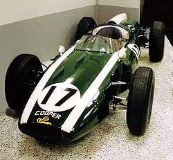 Photograph of the front of the Cooper T51 racing car. It is fairly cylindrical in shape, coloured green, with two white racing stripes, and the number 17 on the bonnet.