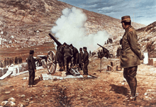Heavy guns firing, with man in general's uniform standing and observing them to the right