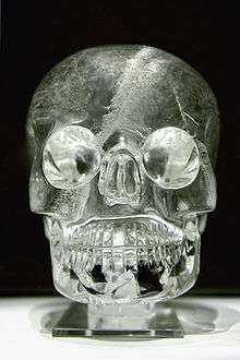 A crystal skull, shining under the light.